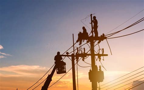Silhouettes Electrician Working On Poles To Install Stock Photo Image