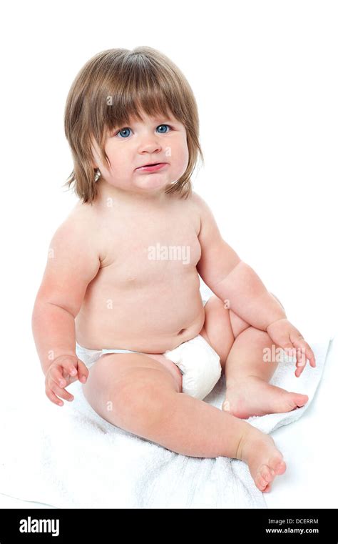 Cute Baby Girl Sitting Up Wearing A Diaper Isolated On White Stock Photo Alamy