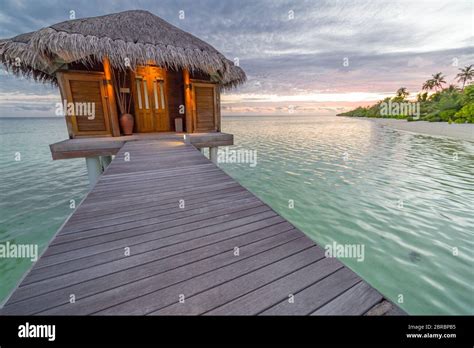 beautiful isolated luxury water bungalows sunset view maldives in the blue green ocean of the