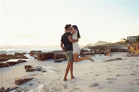 Romantic Couple Kissing On The Beach By Stocksy Contributor Jacob