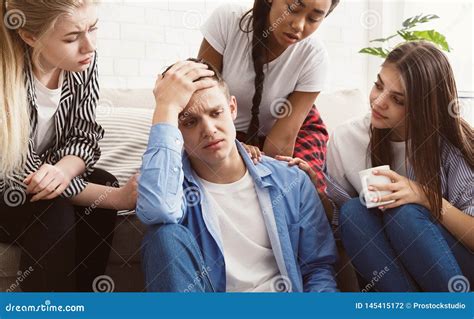Young People Comforting Their Upset Friend At Home Stock Photo Image