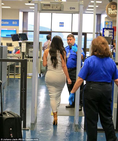 Kim Kardashian Takes Off Her Heels As She Goes Through Airport Security
