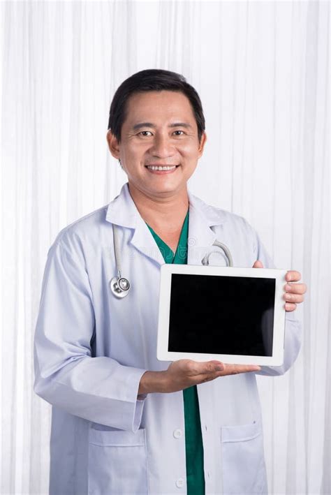 Male Medicine Doctor Holding Digital Tablet Pc And Showing Scree Stock