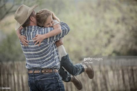 Caucasian Father Lifting And Hugging Daughter Photo Getty Images
