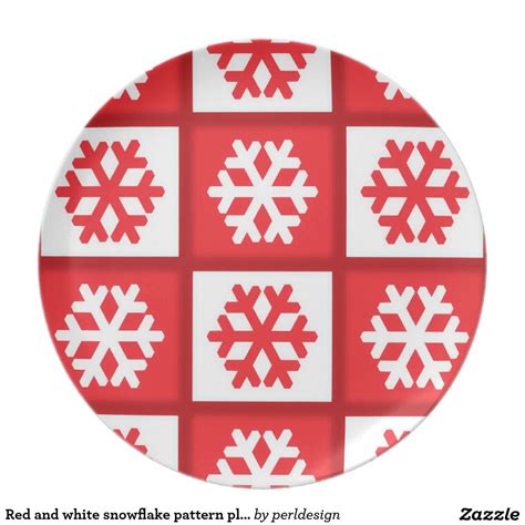 A Red And White Plate With Snowflakes Printed On The Front In Squares