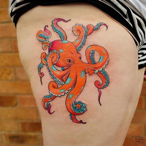 An Orange Octopus Tattoo On The Back Of A Womans Thigh With Blue And