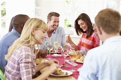 Group Of Friends Sitting Around Table Having Dinner Party Background