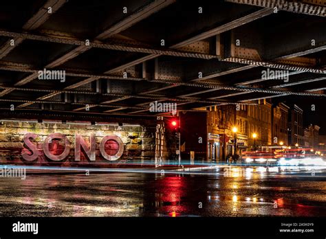 A Long Exposure Photo Of The Sono Sign Under The Train Tracks In South