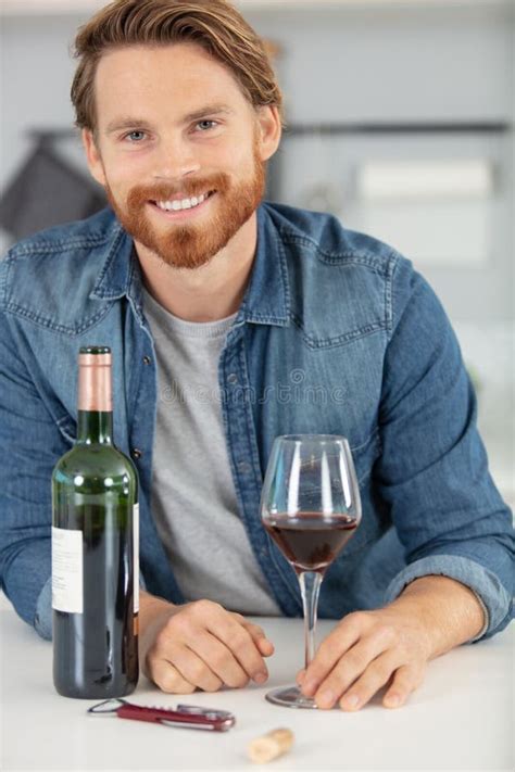 Handsome Young Man Smiling And Holding Glass Red Wine Stock Photo