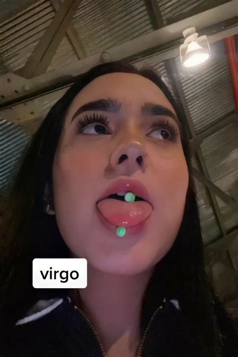 A Woman Is Making A Face With Her Tongue Out And The Words Virgo Written In Front Of Her