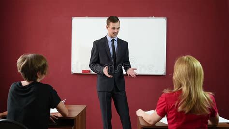 Educational Theme Portrait Of A Teacher Giving A Lecture Busty Teacher In Front Of Male