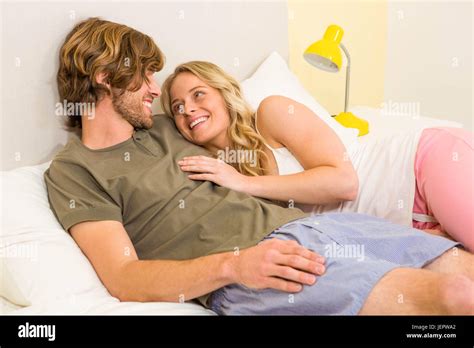 Cute Couple Cuddling On Their Bed Stock Photo Alamy