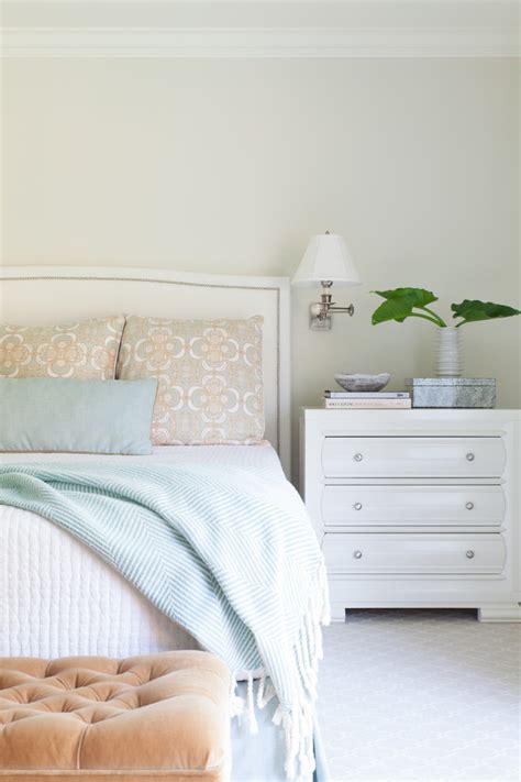 The bed frame is a lilac color with a turquoise comforter on top of it. Nest Design Co. | House of Turquoise