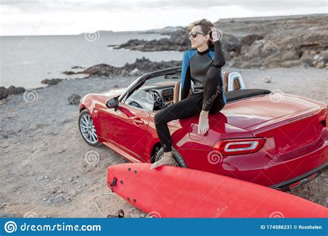 Young Surfer With Surfboard On The Sports Car On The Beach Stock Image