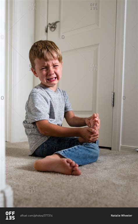Crying Boy Holding His Foot Stock Photo Offset