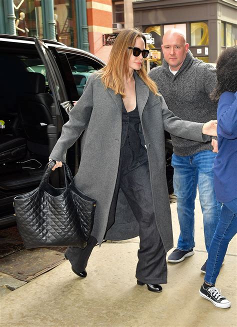 Angelina Jolie Styles A Luxe Vest Suit With Her Go To Bag Flipboard