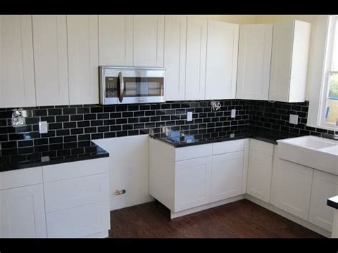 Backsplash Ideas for Black Granite Countertops and White ... White kitchen with 4x12 glass backsplash tiles, caesarstone countertops, wolf range, benjamin moore painted cabinets, persian rug inspiration for a coastal kitchen remodel in los angeles with stainless steel appliances, quartz countertops and white backsplash white flat tile.