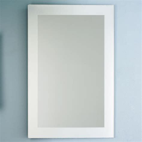 A Bathroom Mirror Sitting On Top Of A Blue Wall Next To A Toilet Paper
