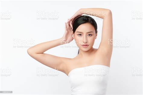 Beautiful Young Asian Woman Lifting Hands Up To Show Off Clean And Hygienic Armpits Or Underarms