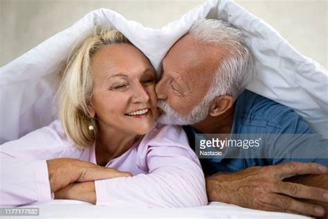 older couple kissing bed photos and premium high res pictures getty images