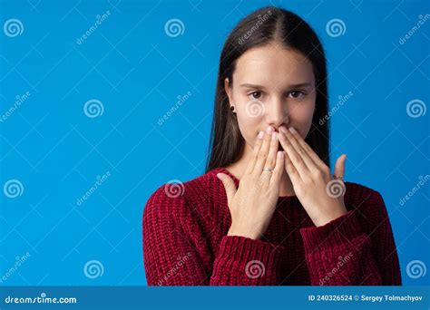 Dissapointed Young Teen Girl Covering Her Mouth Against Blue Background