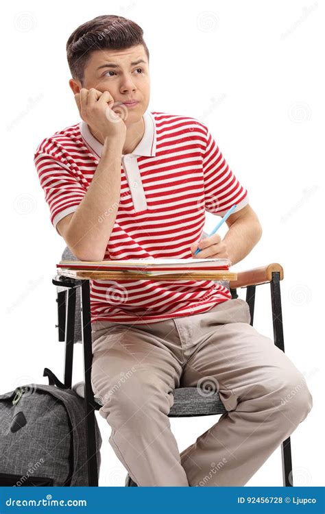 Teen Student Sitting In A School Chair And Taking Notes Stock Photo