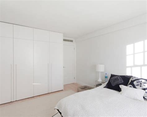 I used modular closets to design a pallet wall walk in closet with slanted ceilings. Floor To Ceiling Closets | Houzz