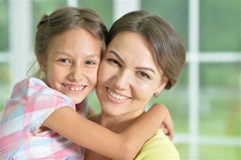 Portrait Of A Charming Little Girl Hugging With Mom At Home Stock Photo