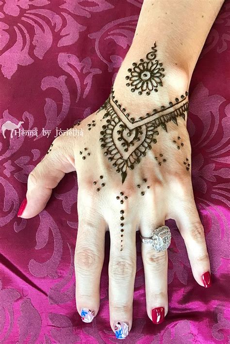 Easy henna designs are popular among those who are still new in this type of tattoo. small and simple henna on hand | Henna hand tattoo, Hand henna, Hand tattoos