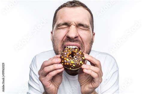 This Guy Is Starving So He Is Eating A Big Fat Chocolate Donut He Has