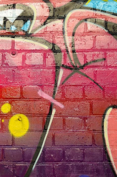 Abstract Colorful Fragment Of Graffiti Paintings On Old Brick Wall In Pink And Green Colors