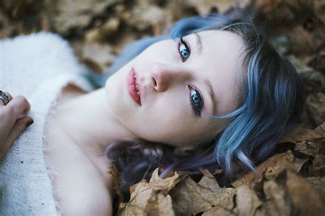 Portrait Of A Beautiful Young Woman Lying Down In Autumn Leaves By Stocksy Contributor Jovana