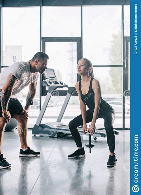 Male Personal Trainer Looking At Sportswoman Stock Photo Image Of