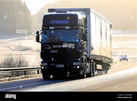 Black Scania R620 Truck Of Fe Trans Oy Pulls Trailer Uphill In Rural