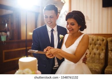 Happy Bride Groom Cutting Their Stylish Stock Photo