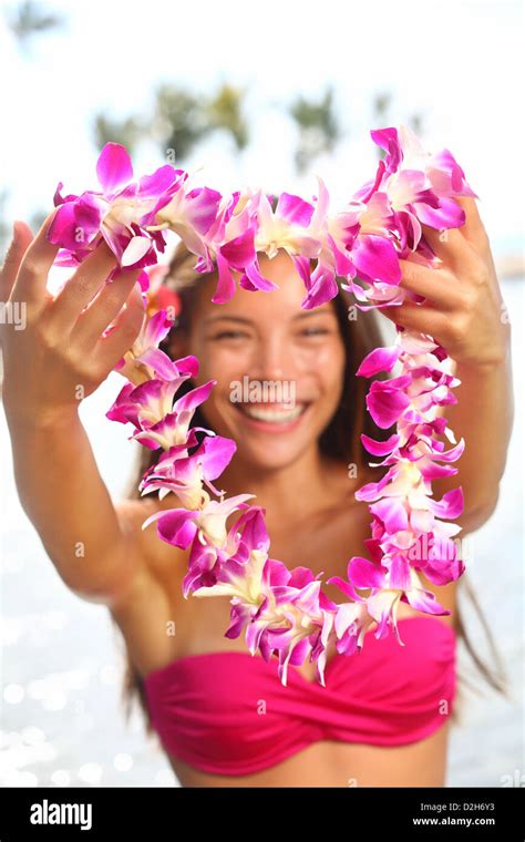 Smiling Woman With Lei White Bikini Holding Pink Umbrella At Beach