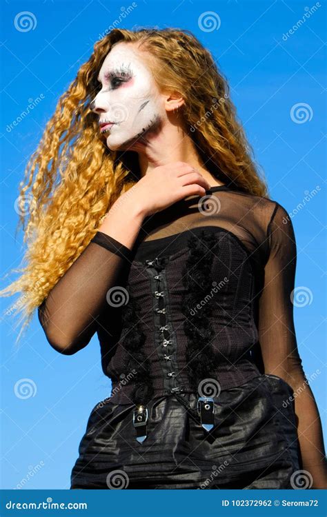 Zombie Girl With Black Eyes And A Bloody Mouth On Halloween Stock Photo