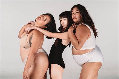 Asian women with different bodies hugging in studio · Free Stock Photo