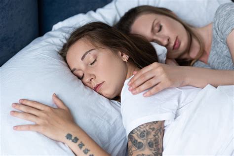 Two Lesbians Embracing While Sleeping Under Blanket In Bed Free Stock