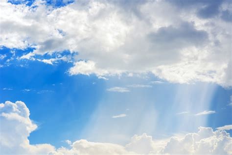 Premium Photo Sunbeam Through The Haze On Blue Sky Clouds With Sun Rays