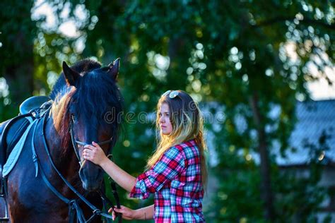 Beautiful Girl With Long Hair On A Walk With A Horse Stock Image
