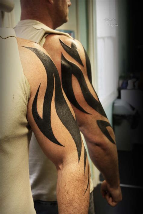 Explore masculine black ink ideas across the arms. TATTOOinc-Tribal Tattoo Gallery