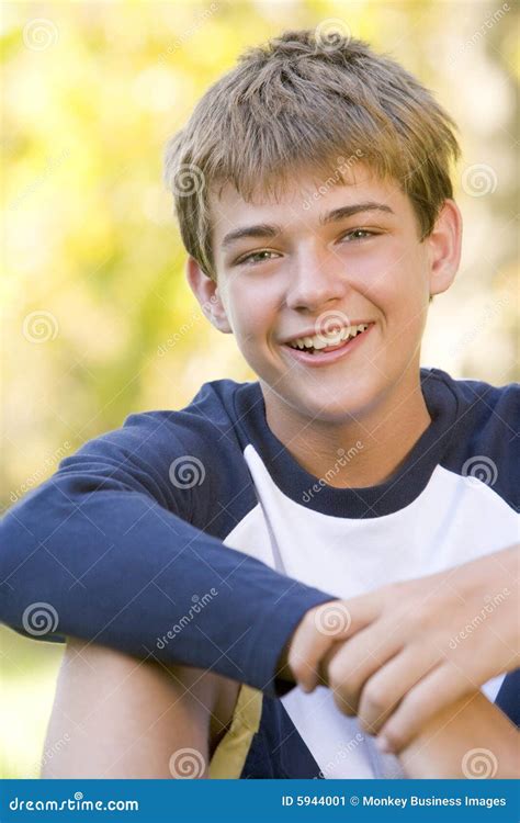 Young Boy Sitting Outdoors Smiling Stock Image Image Of Kids Daytime
