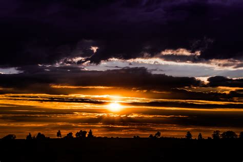 Dark Clouds And Sunrise Sky With Sun And Rays Hoodoo Wallpaper