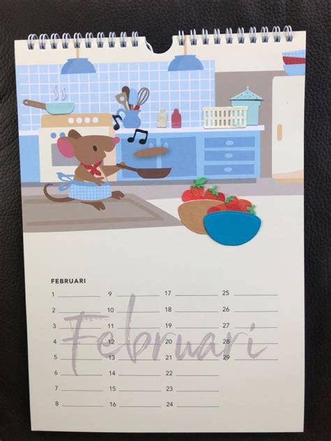 A Calendar With An Image Of A Mouse In The Kitchen On Its Cover