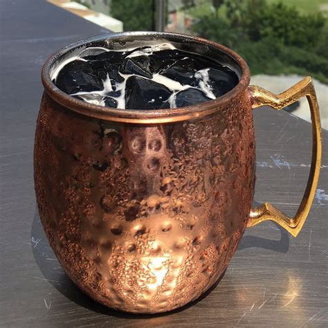 Try experimenting with flavored simple. This Kentucky Mule variation is gold and black, just like ...