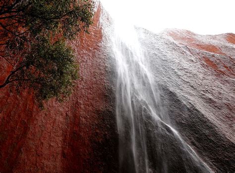 Rain Storm Uluru Ayers Rock In The Rain Waterfalls On Uluru During A Rare Rainstorm Stock