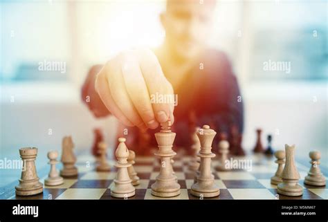 Businessman Play With Chess Game Concept Of Business Strategy And