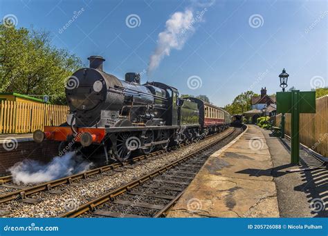 Steam Trains Passing At A Station On A Railway Line In Sussex Uk Stock