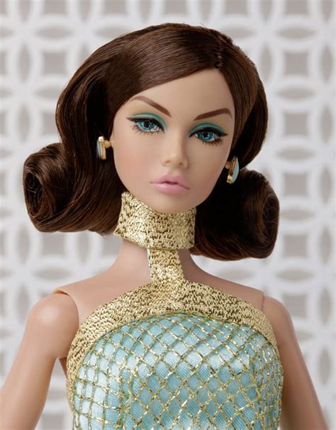 A Close Up Of A Doll Wearing A Dress With Gold And Blue Beads On Its Neck
